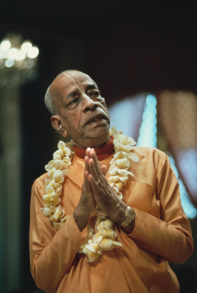 Srila Prabhupada with flower garland, offering namaste