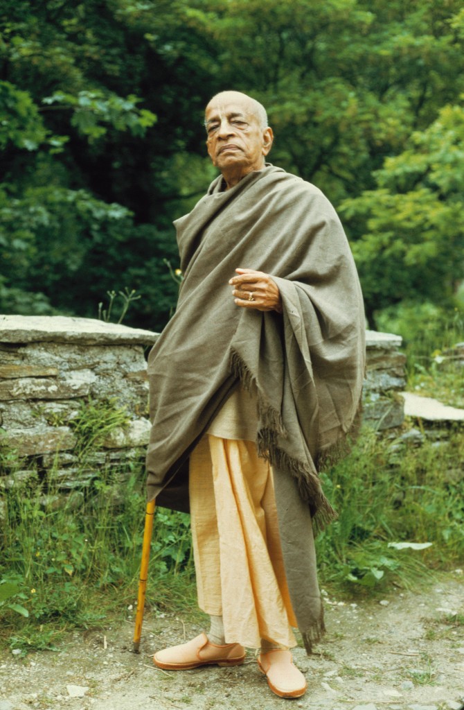 Srila Prabhupada with walking stick in nature
